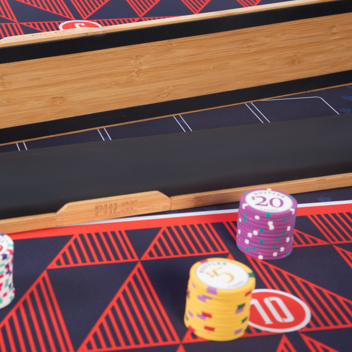 Close-up of the PULSE bamboo rail and padded armrest with chips in play
